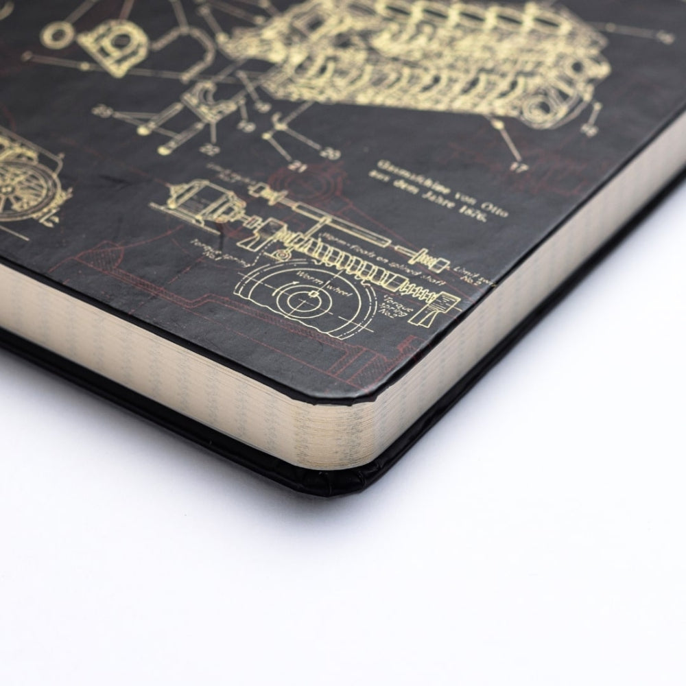 Close-up of a notebook with technical drawings on the cover