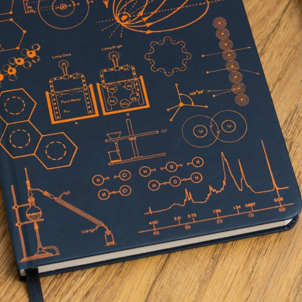 A5 Chemistry Notebook with scientific illustrations on a wooden surface