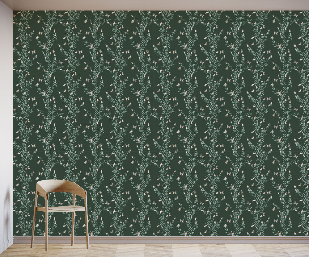 Green patterned wallpaper with a chair in front