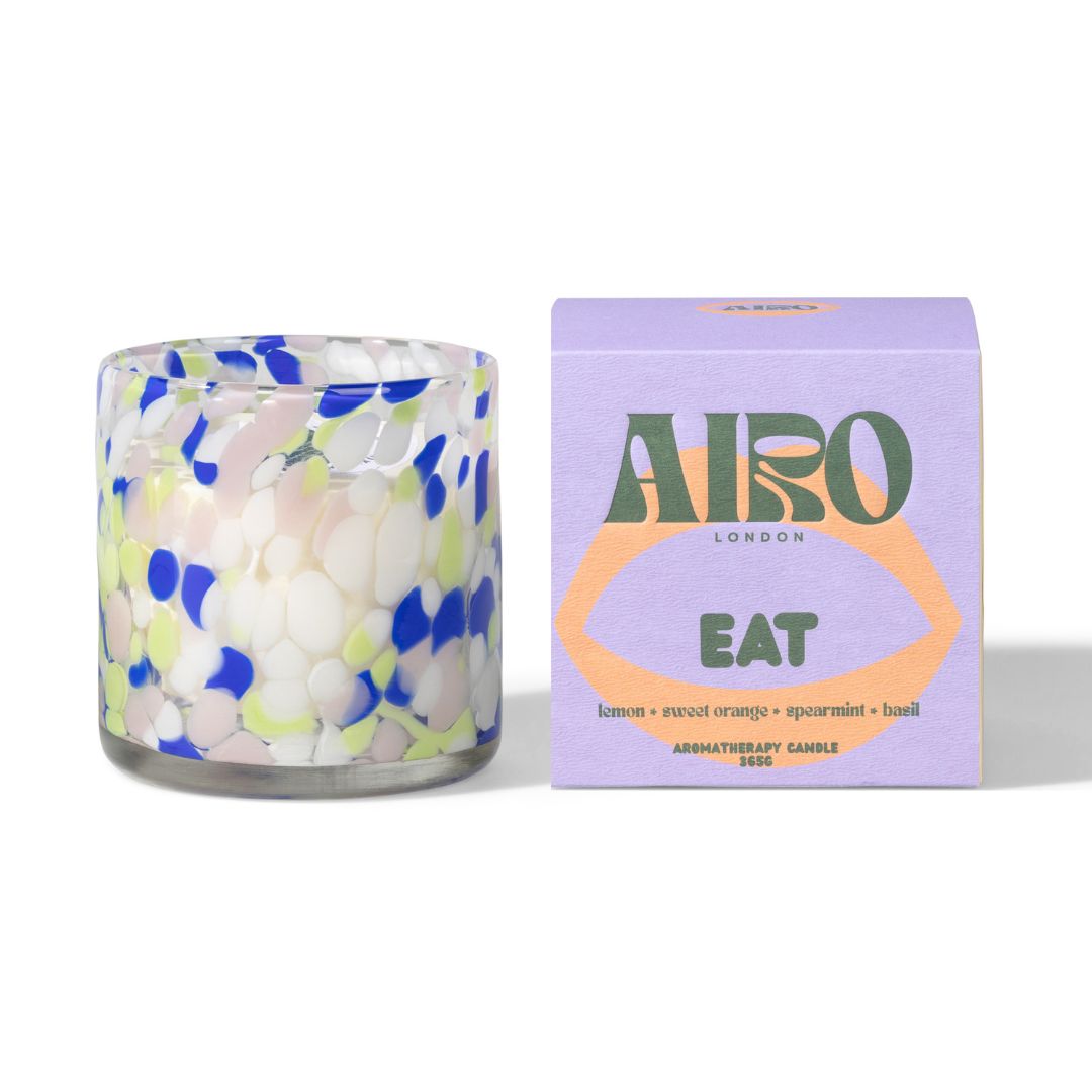 Candle with floral pattern and Airo London packaging on a white background