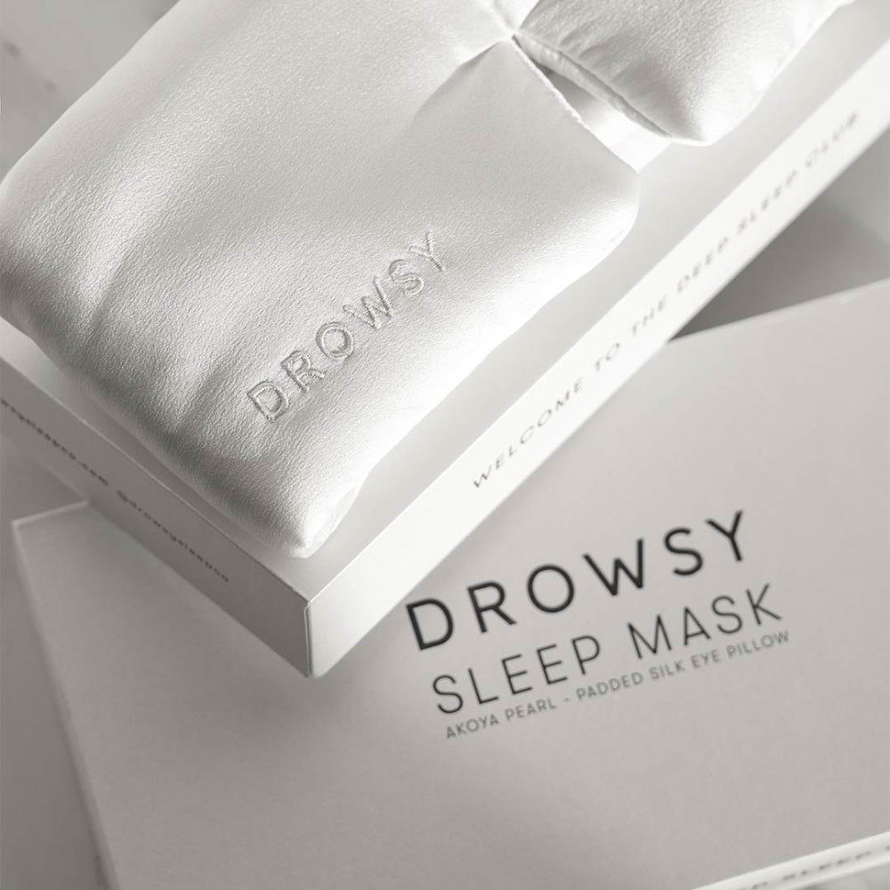 White sleep mask with packaging on a light background