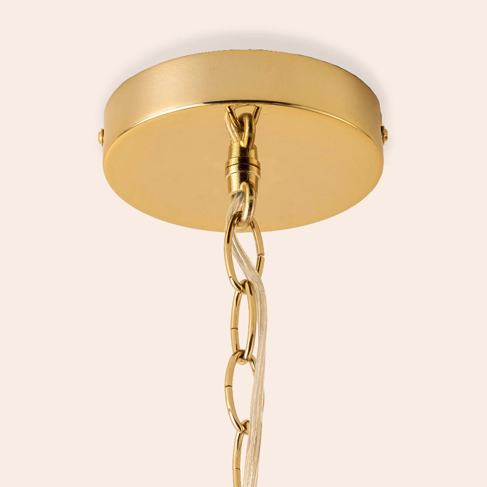 Gold ceiling light fixture with chain on a beige background