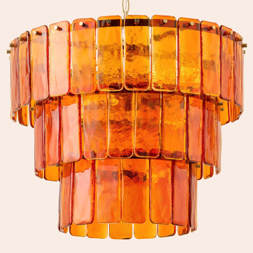 Orange glass chandelier on a beige background