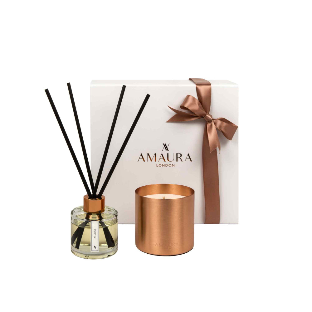 Amaura London diffuser and candle set with a white box featuring a gold ribbon on a white background.