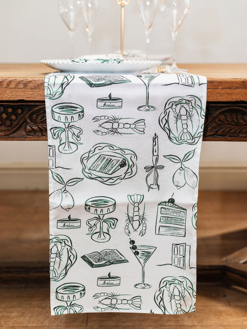 Decorative table runner with line art illustrations on a wooden surface
