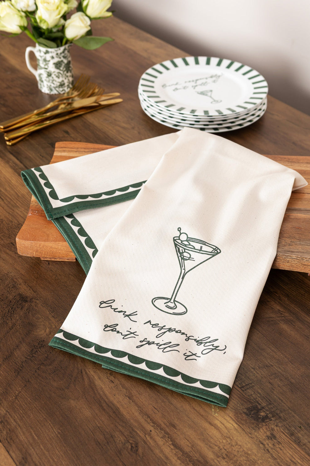 Decorative tea towel with a martini glass design on a wooden table