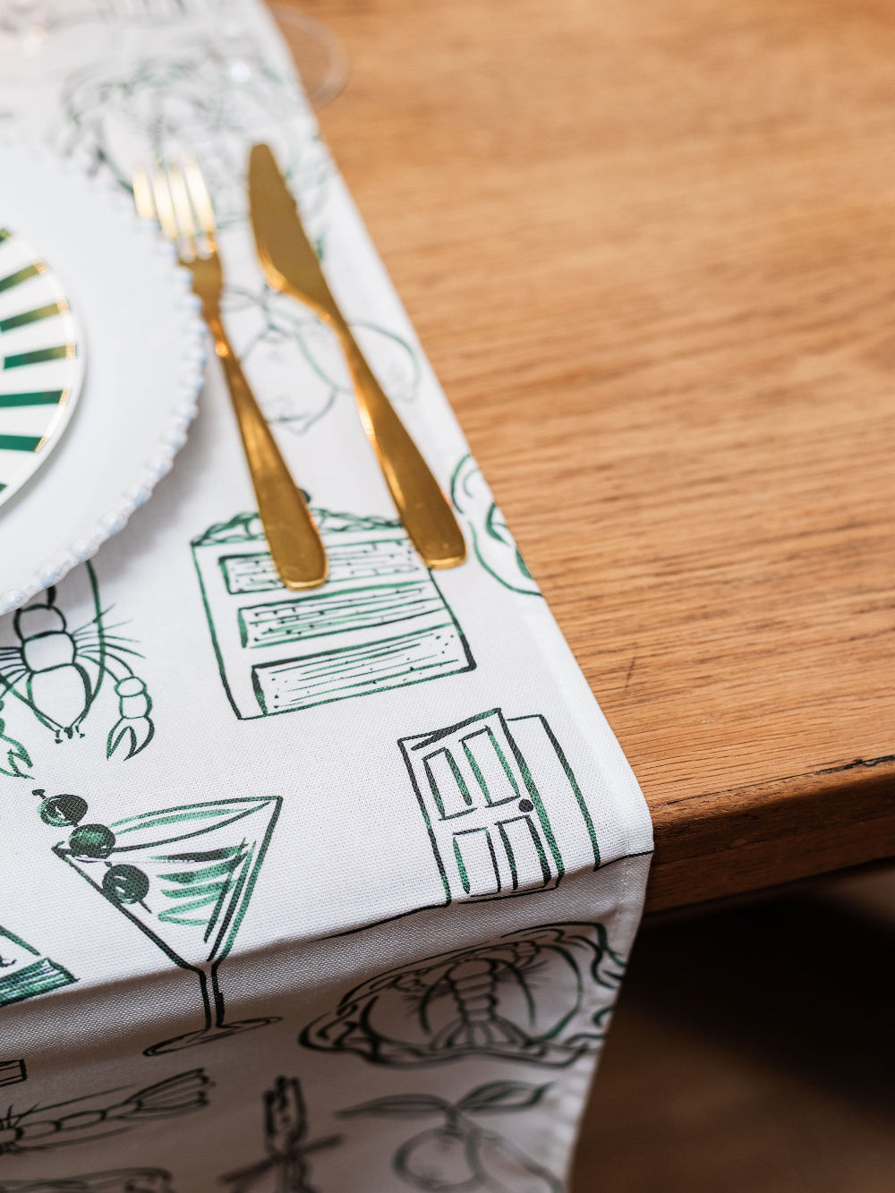 Table runner with cocktail-themed design on a wooden table