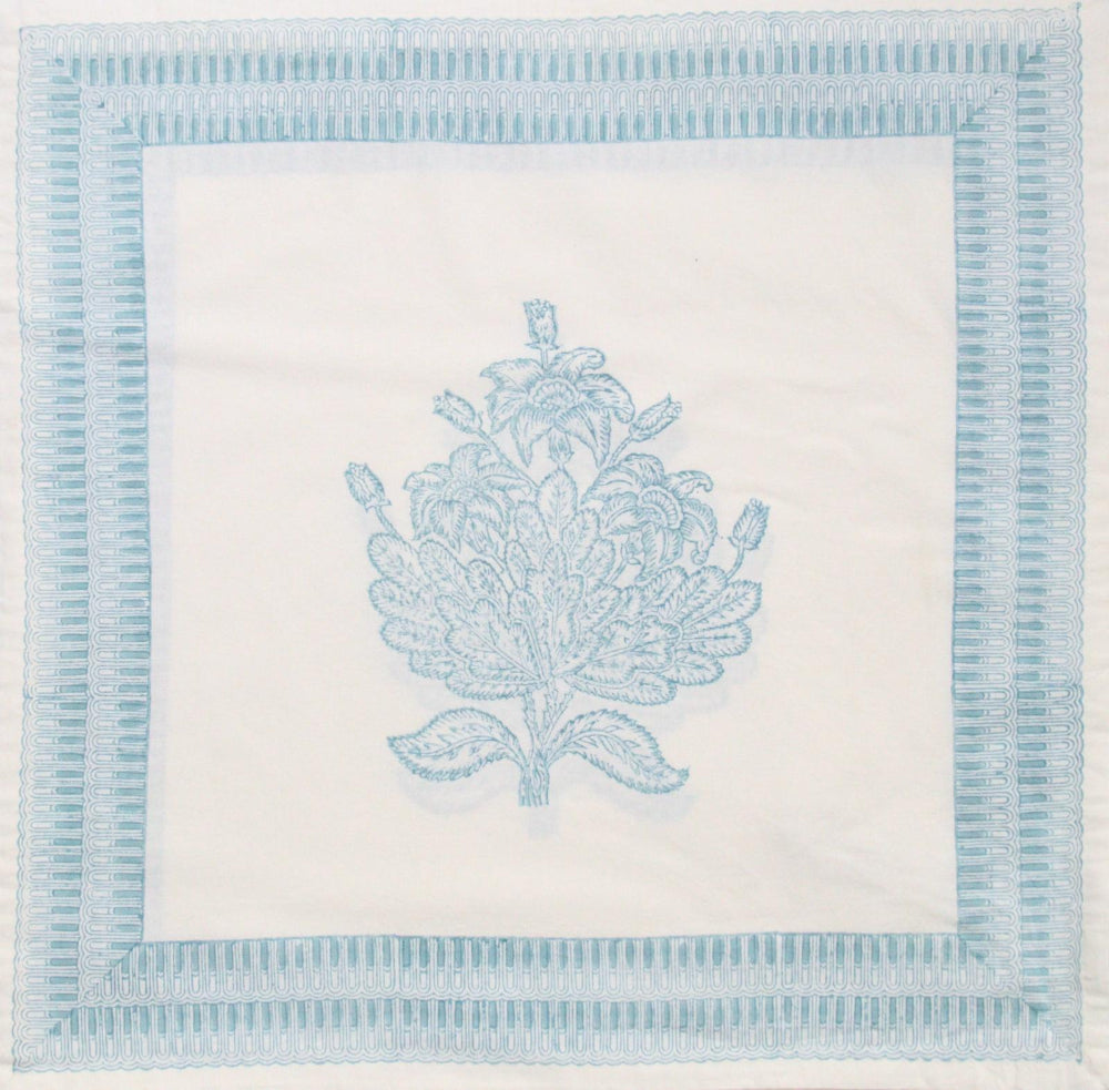 Decorative napkin with blue floral design and border on a white background