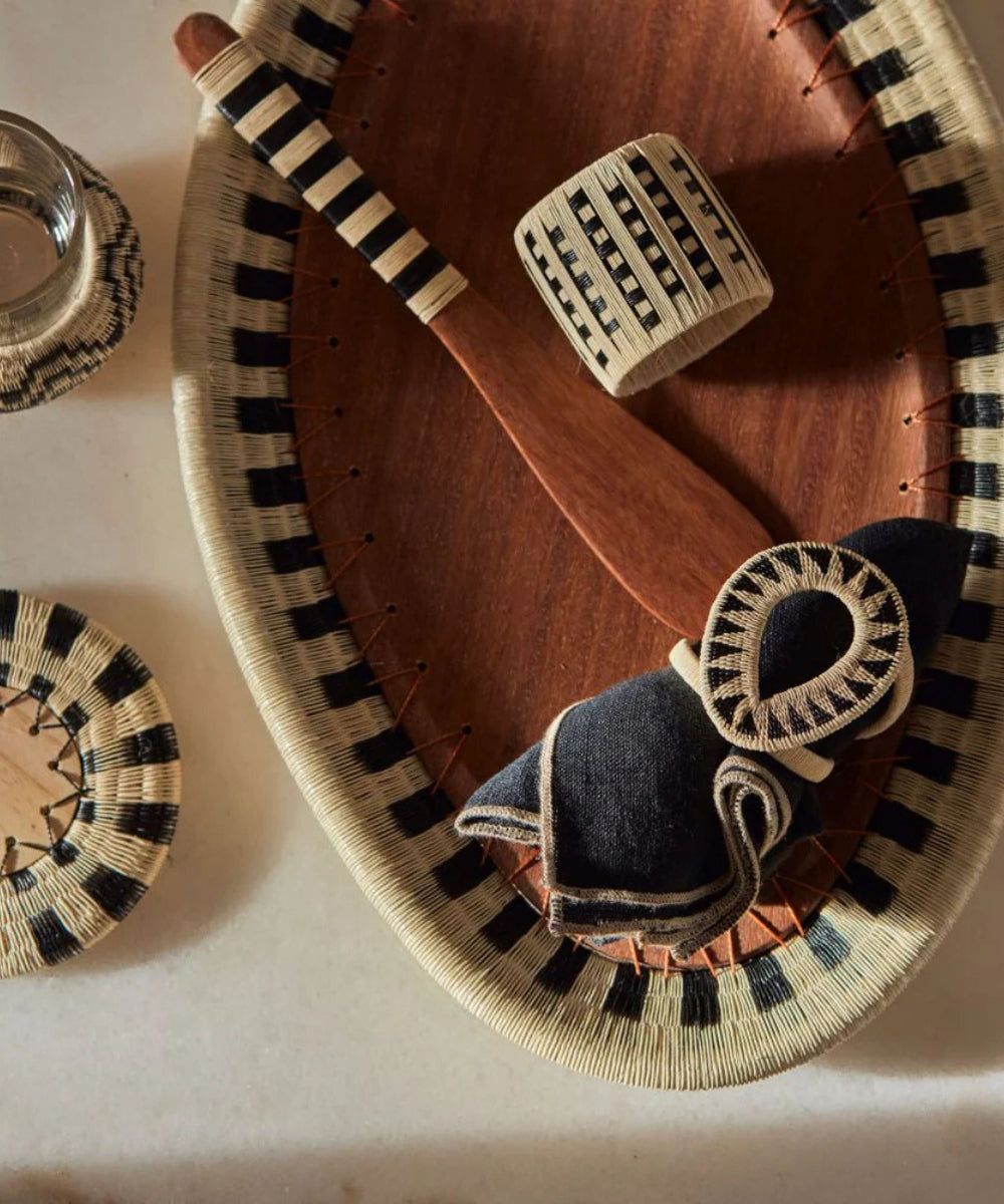 Table setting with natural products including napkin rings, serving tray and wooden spoon