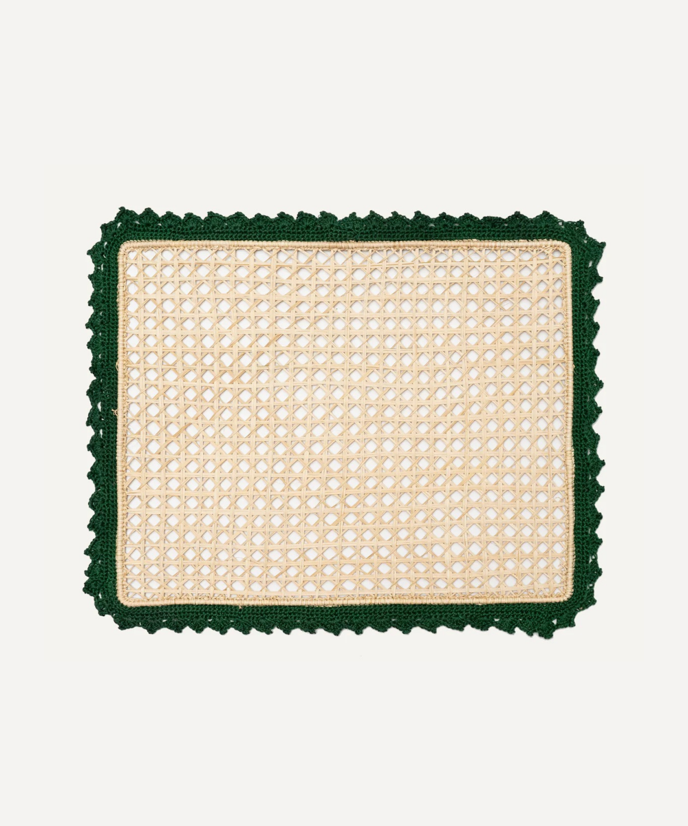 Square woven mat with green border on a white background