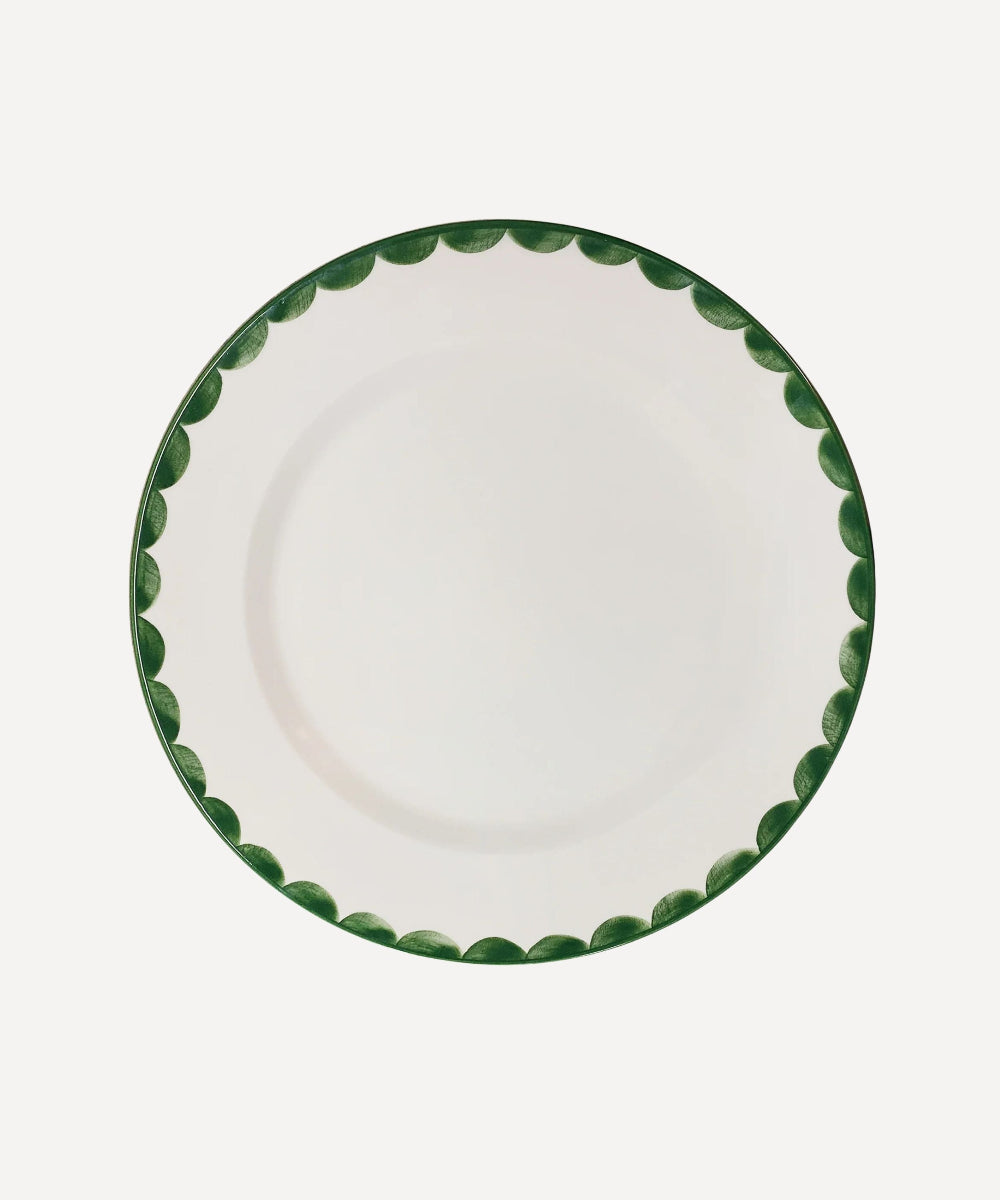 White Ceramic dinner plate with fern green hand-painted scalloped edge on a white background.