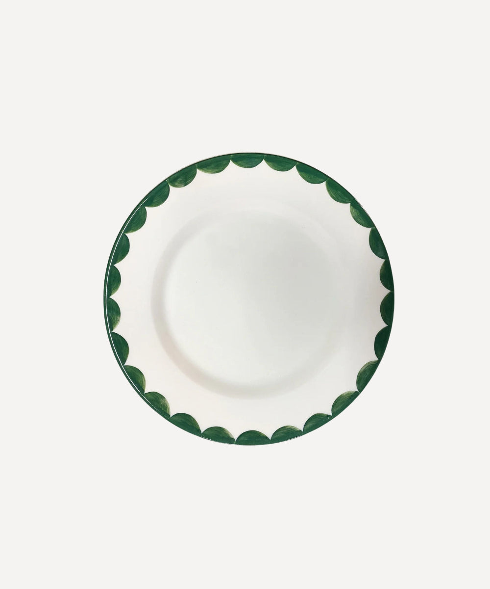 Ceramic white side plate with fern green handpainted rim on a white background