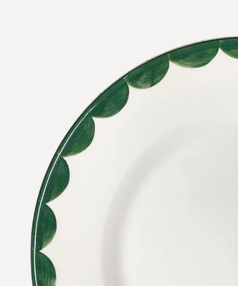 Decorative plate with green leaf pattern on a white background