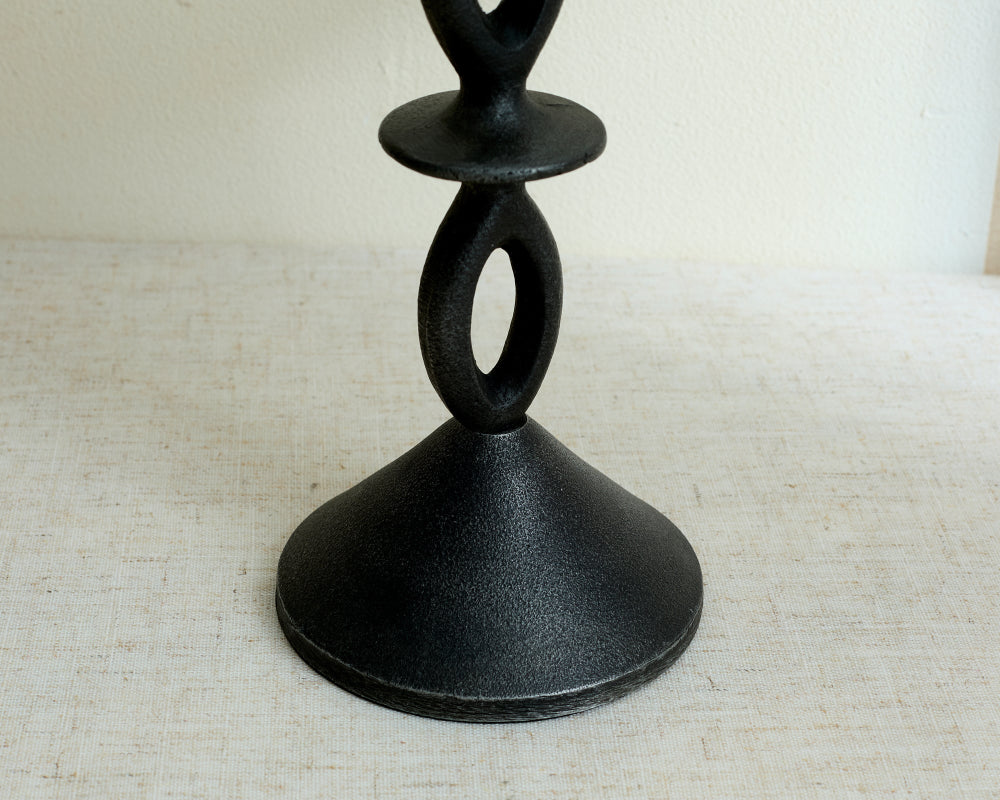 Black wood candle holder on a textured surface