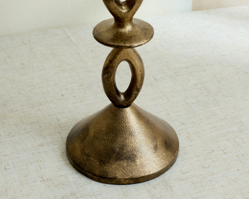 Bronze candle holder on a textured surface