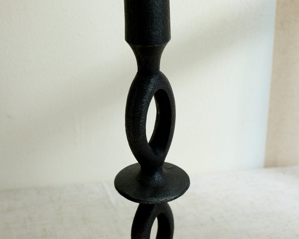 Black wood candle holder on a white background showing close up of centre of holder
