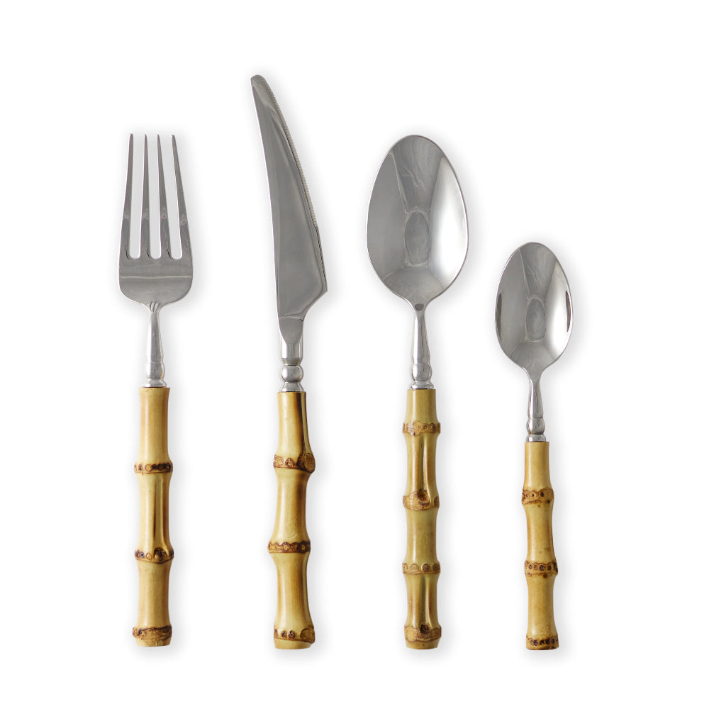 Set of four silver cutlery pieces with bamboo handles on a white background