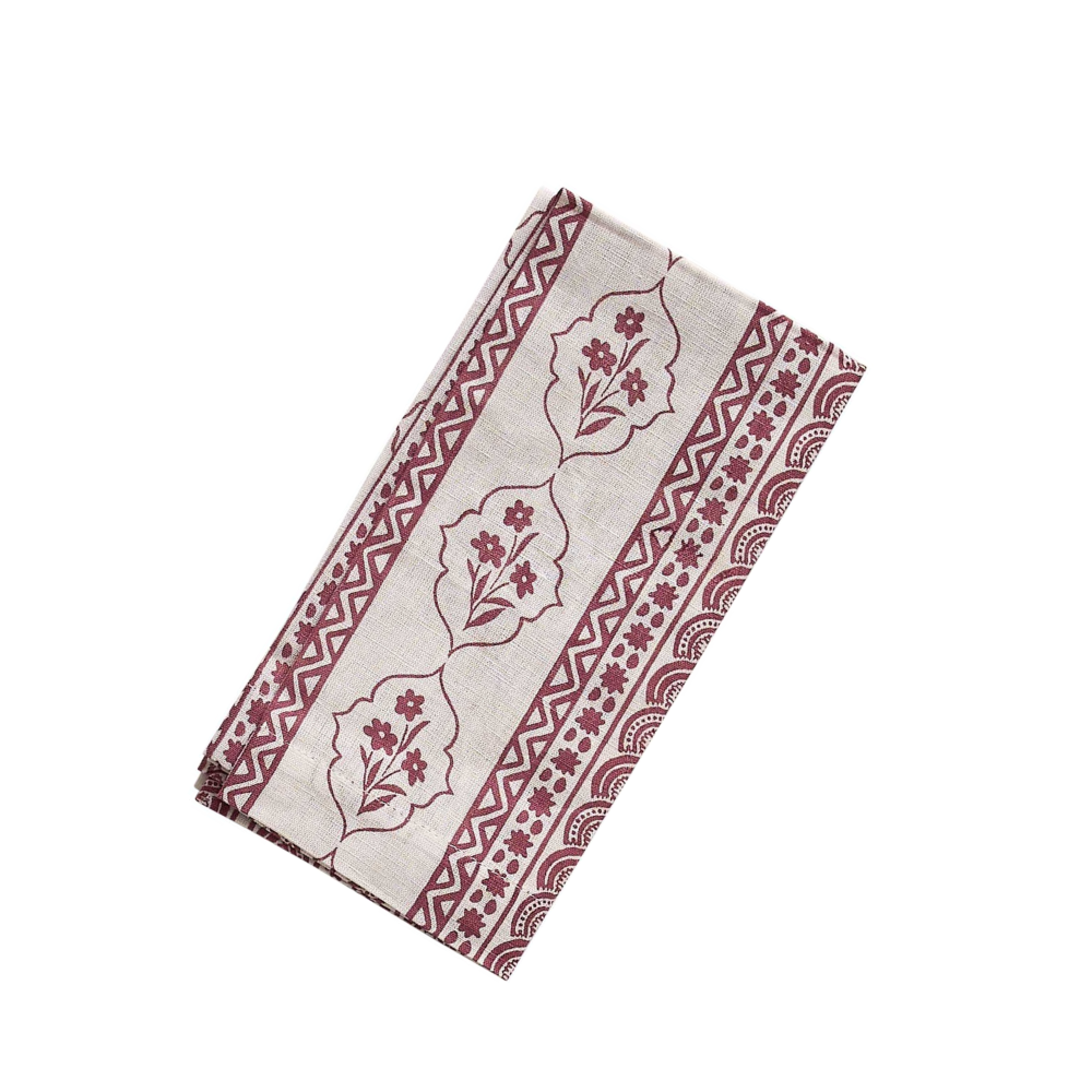 Folded napkin with red geometric and floral patterns on a white background