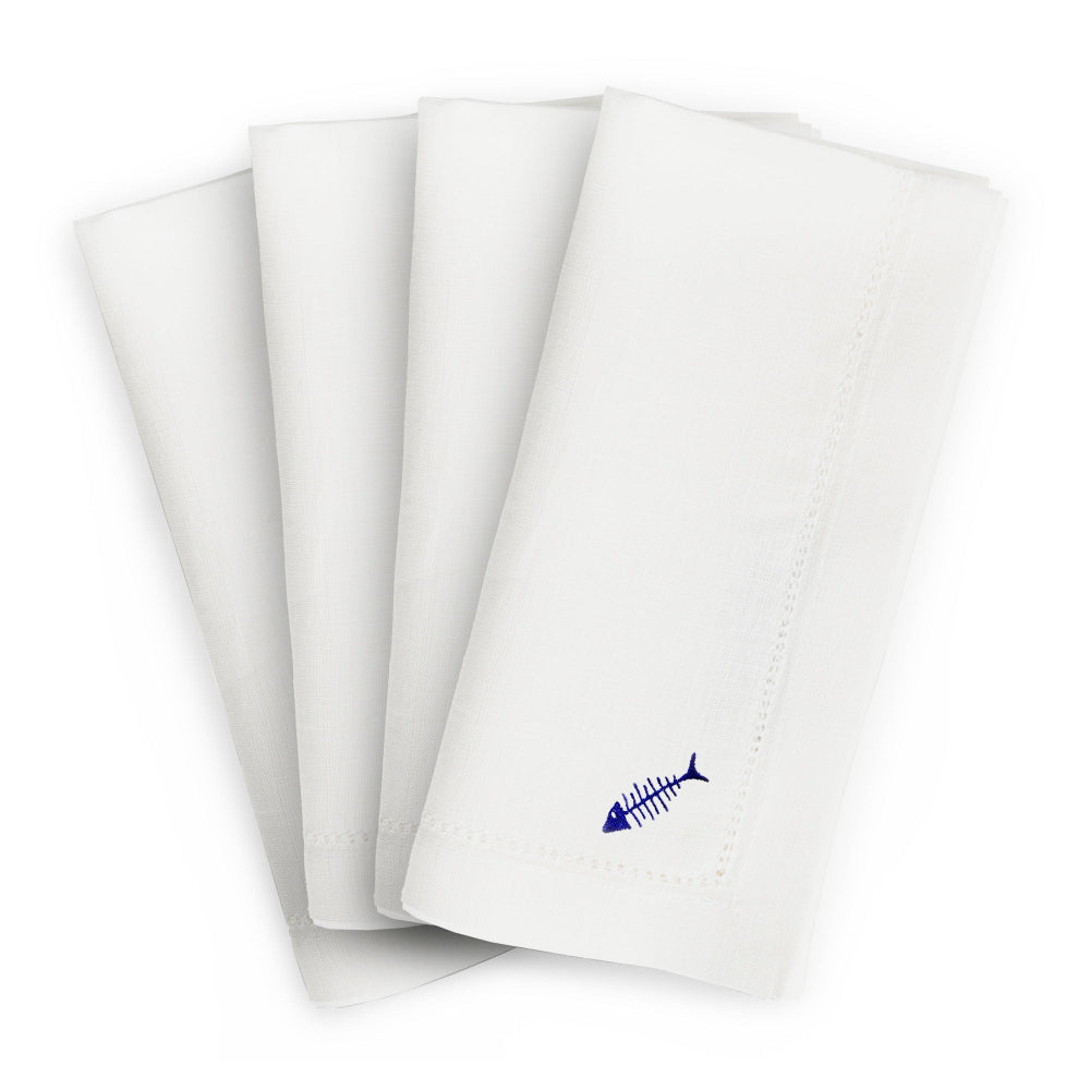 Set of white hemstitched napkins with blue fish embroidered design on a white background