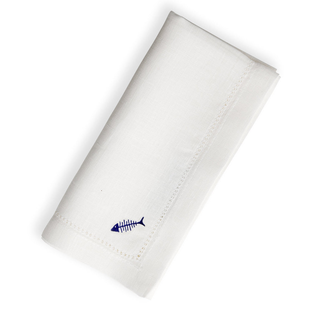 White linen napkin with a blue fishbone design on a white background