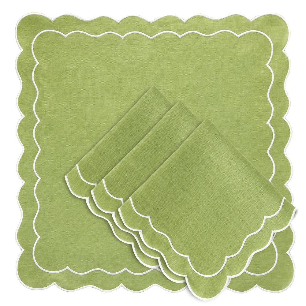 Set of green napkins with scalloped edges on a matching green placemat.