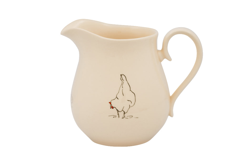 Cream-coloured ceramic pitcher with a chicken illustration on a white background