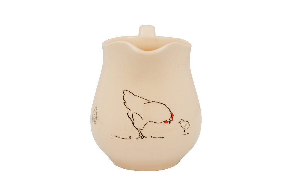 Ceramic pitcher with a design of a rooster and chick on a white background