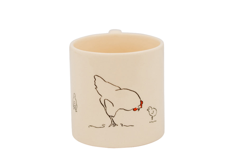 Ceramic mug with a chicken and chick illustration on a white background