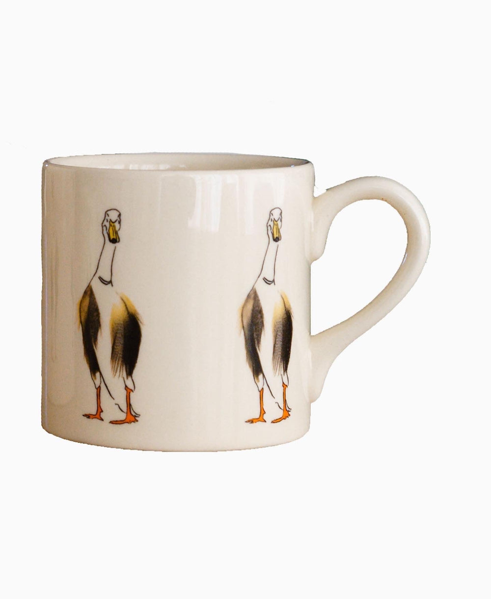Cream mug with duck design on a white background