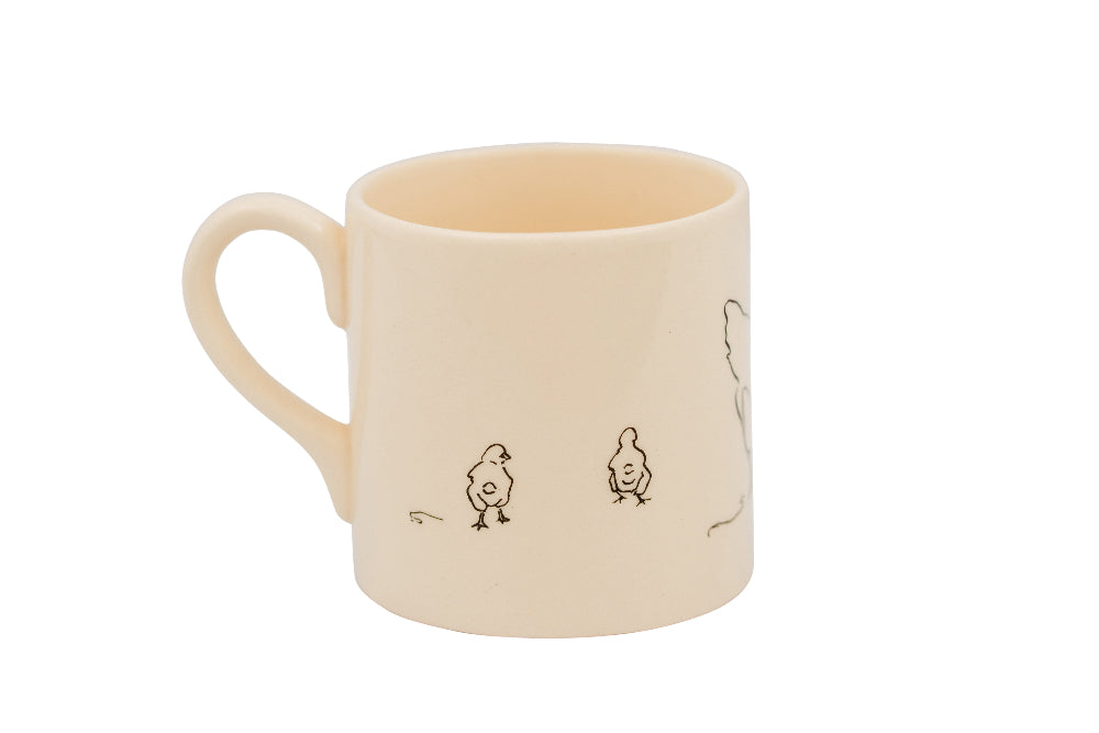 Beige mug with black line drawings of chicks on a white background