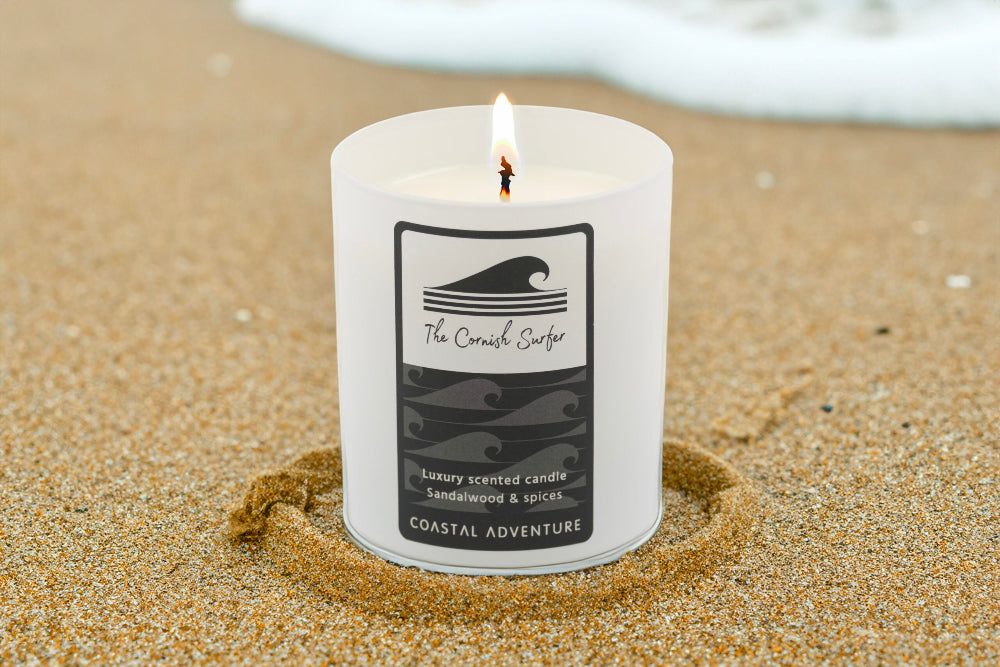 Lit Candle called coastal adventure on sand at a beach
