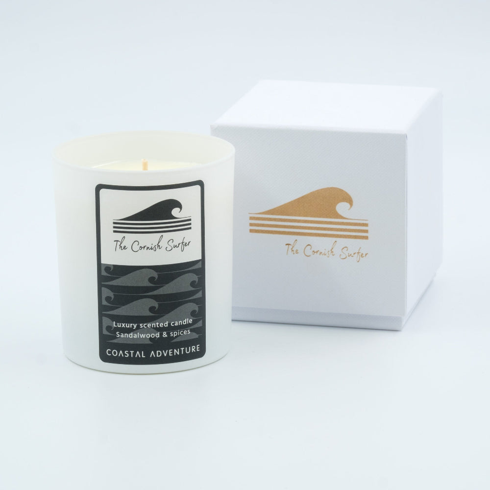 Candle with 'The Cornish Surfer' label and packaging on a white background