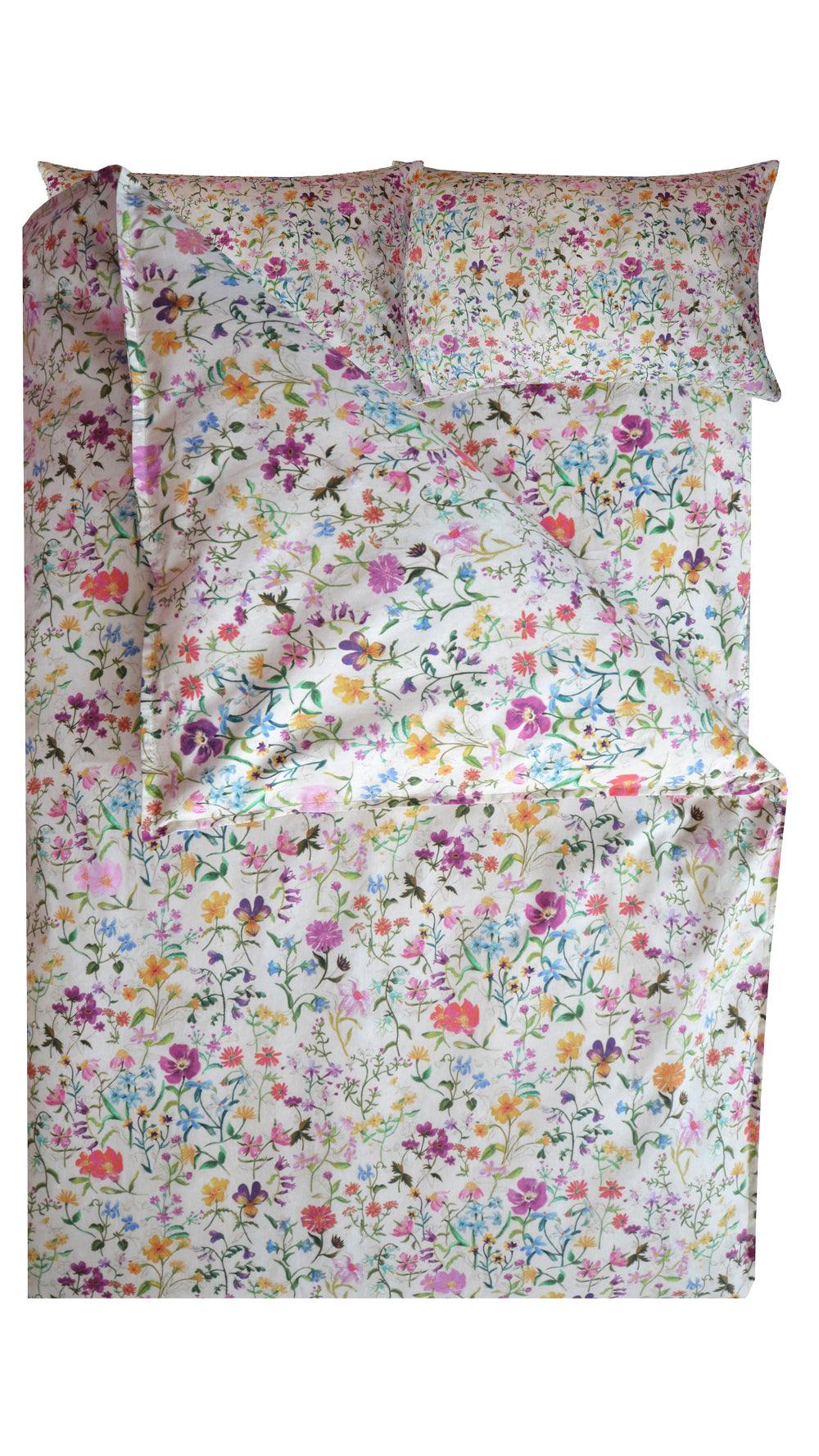 Floral patterned bedding set with matching pillowcases on a white background