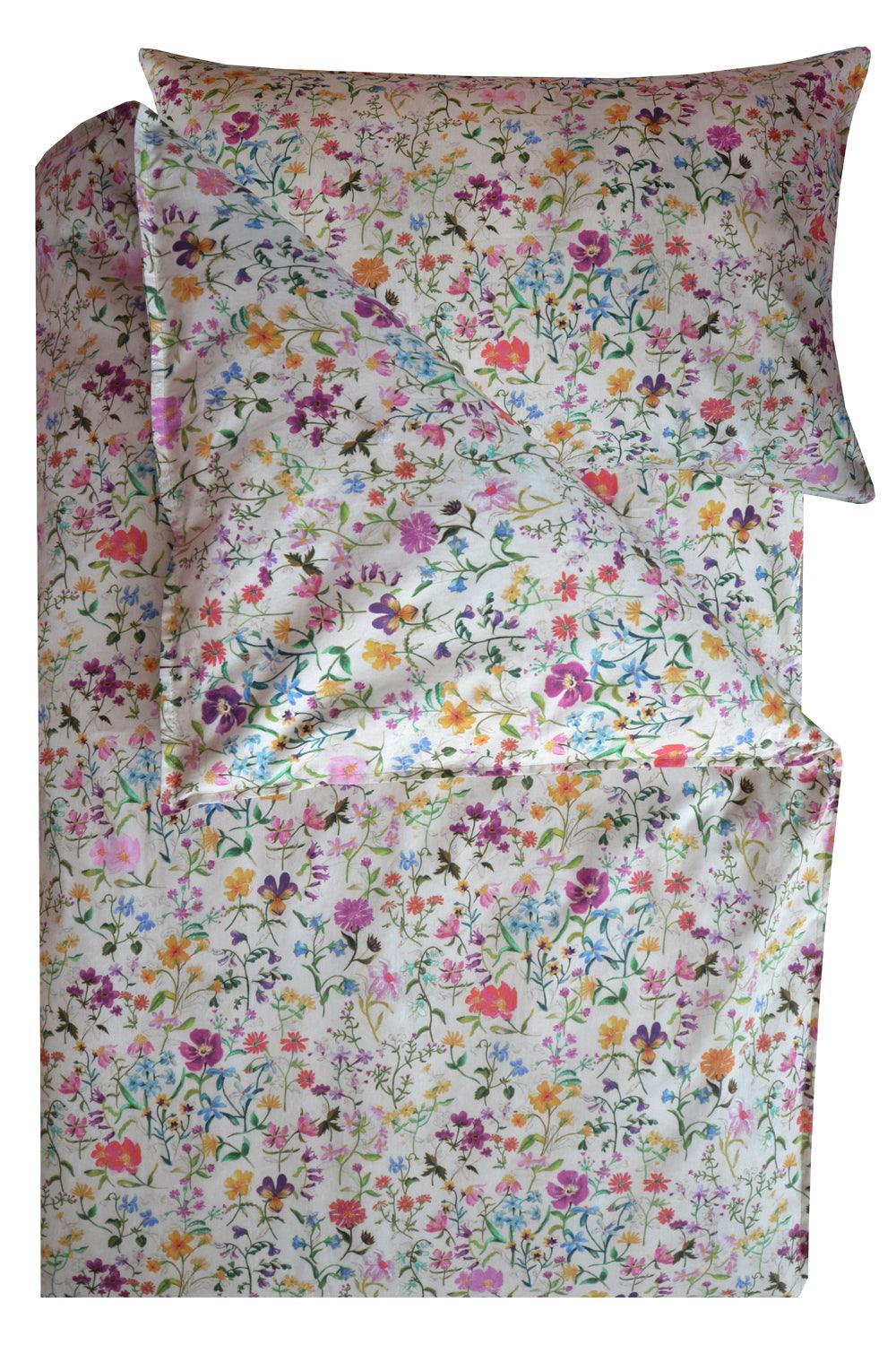 Floral patterned bed sheet set with matching pillowcase on a white background