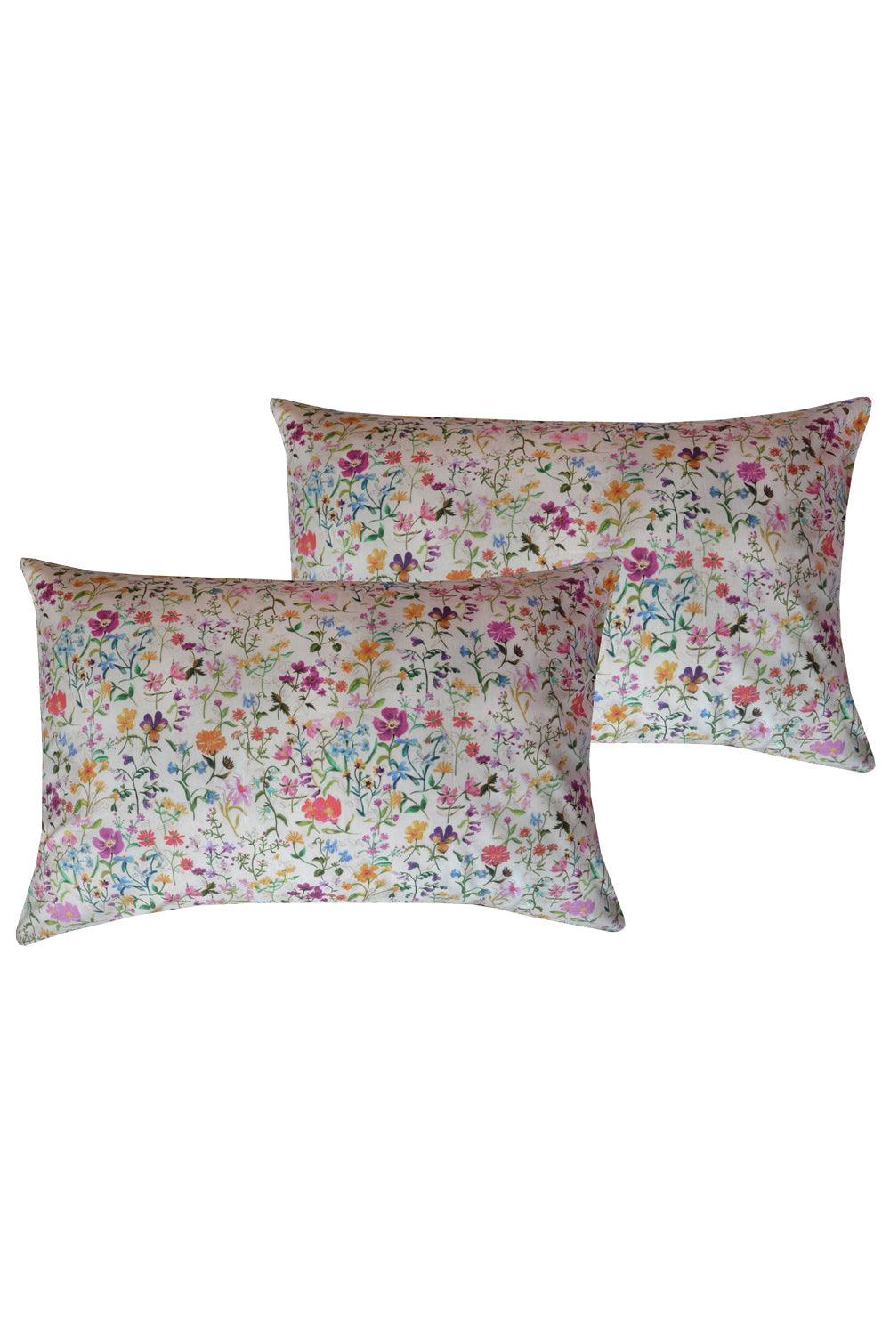 Two floral-patterned pillows on a white background
