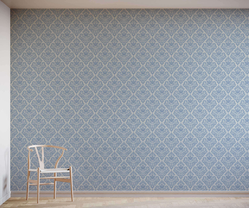 Room with a blue damask patterned wall and a wooden chair.