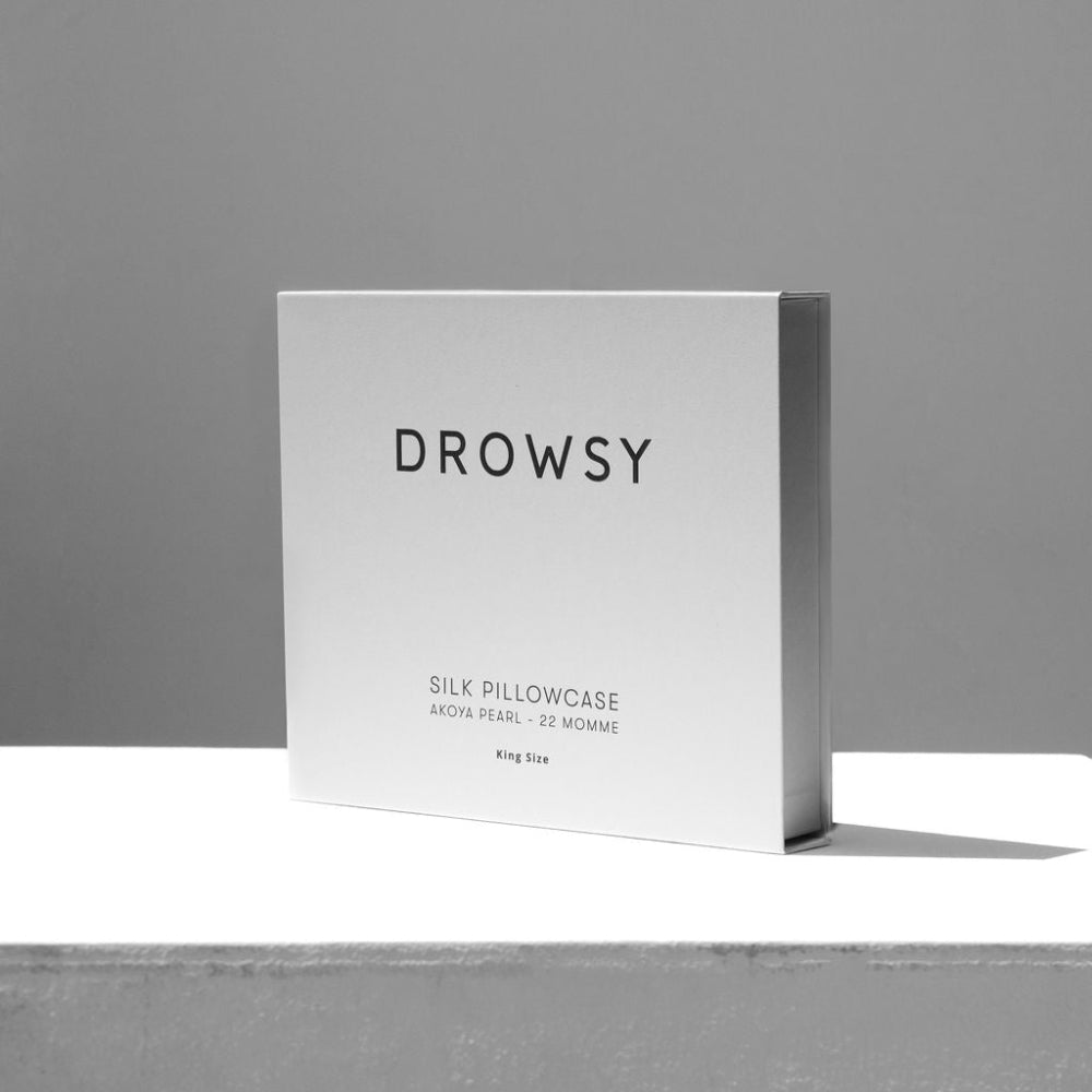 Drowsy white silk Akoya Pearl pillowcase packaging on a grey background