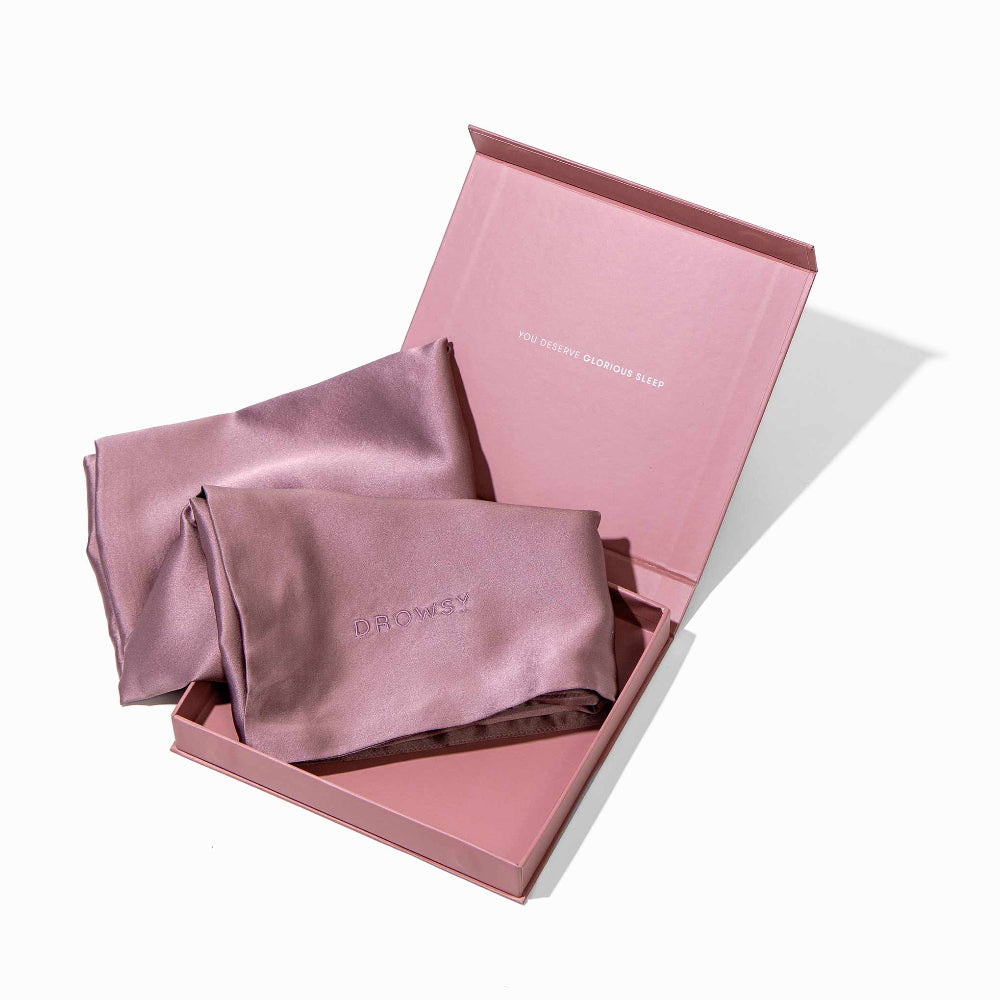 Open box showing contents of a Pink silk pillowcase in a pink box on a white background