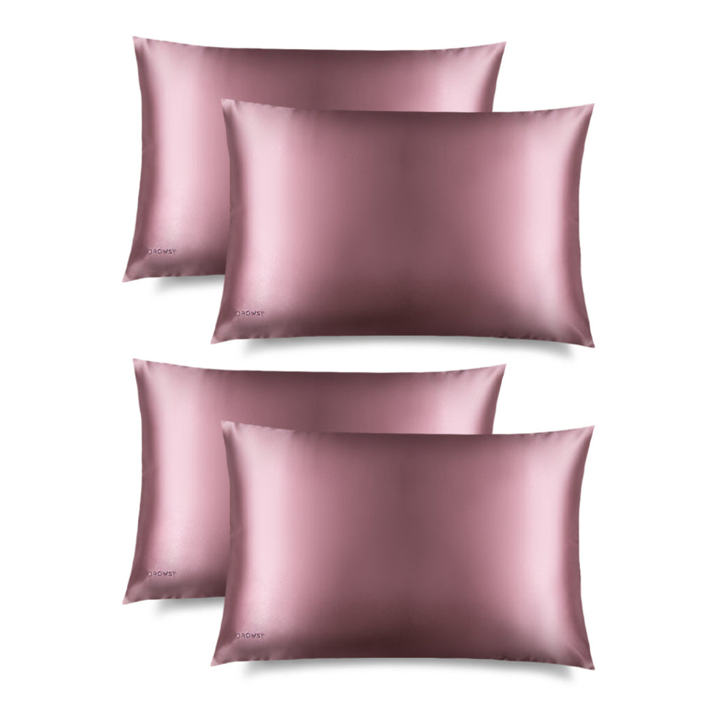 Four pink Drowsy pink pillowcases on a white background