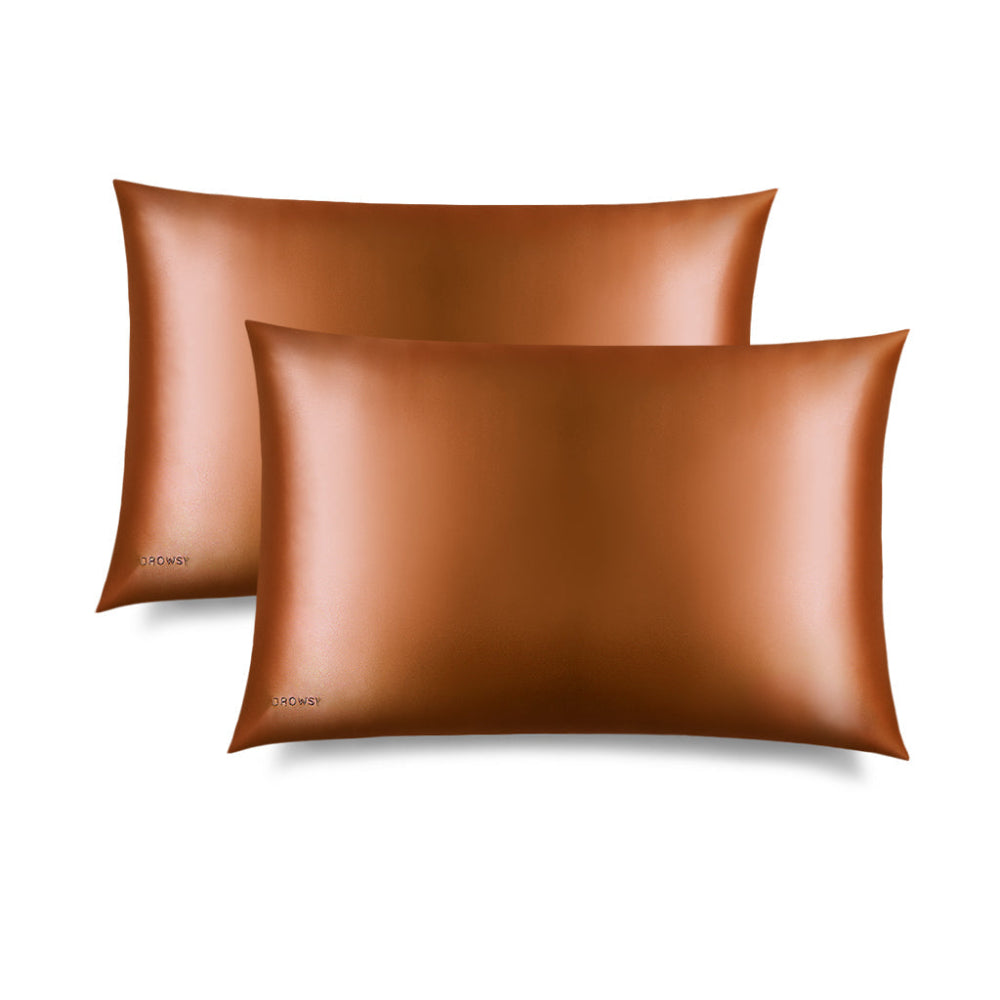 Two Pumpkin Spice silk pillowcases on a white background
