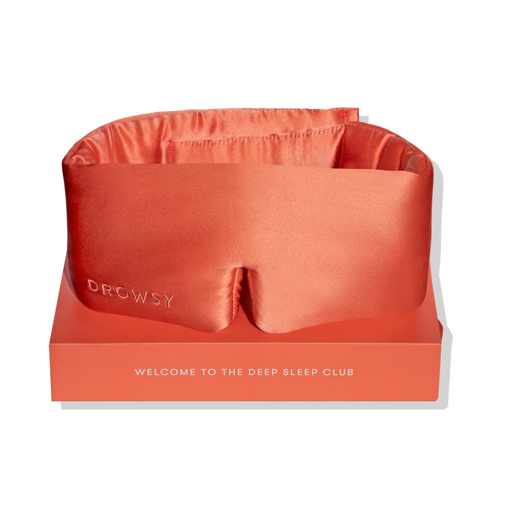 Silk sleep mask on top of a box with brand Drowsy packaging
