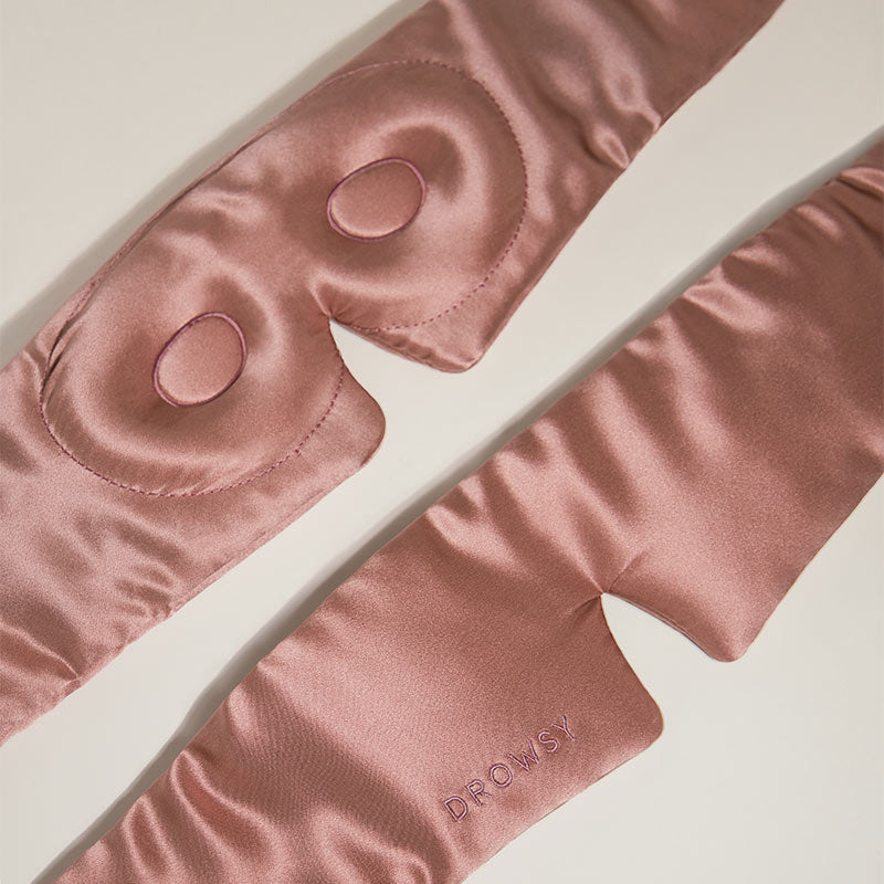 Pink silk eye mask on a light background