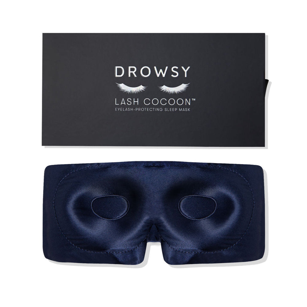 Navy blue sleep mask with lash cocoon packaging on a white background