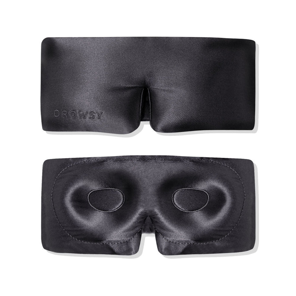 Black sleep mask on a white background showing the eyelash cocoon inner and the front with Drowsy branding