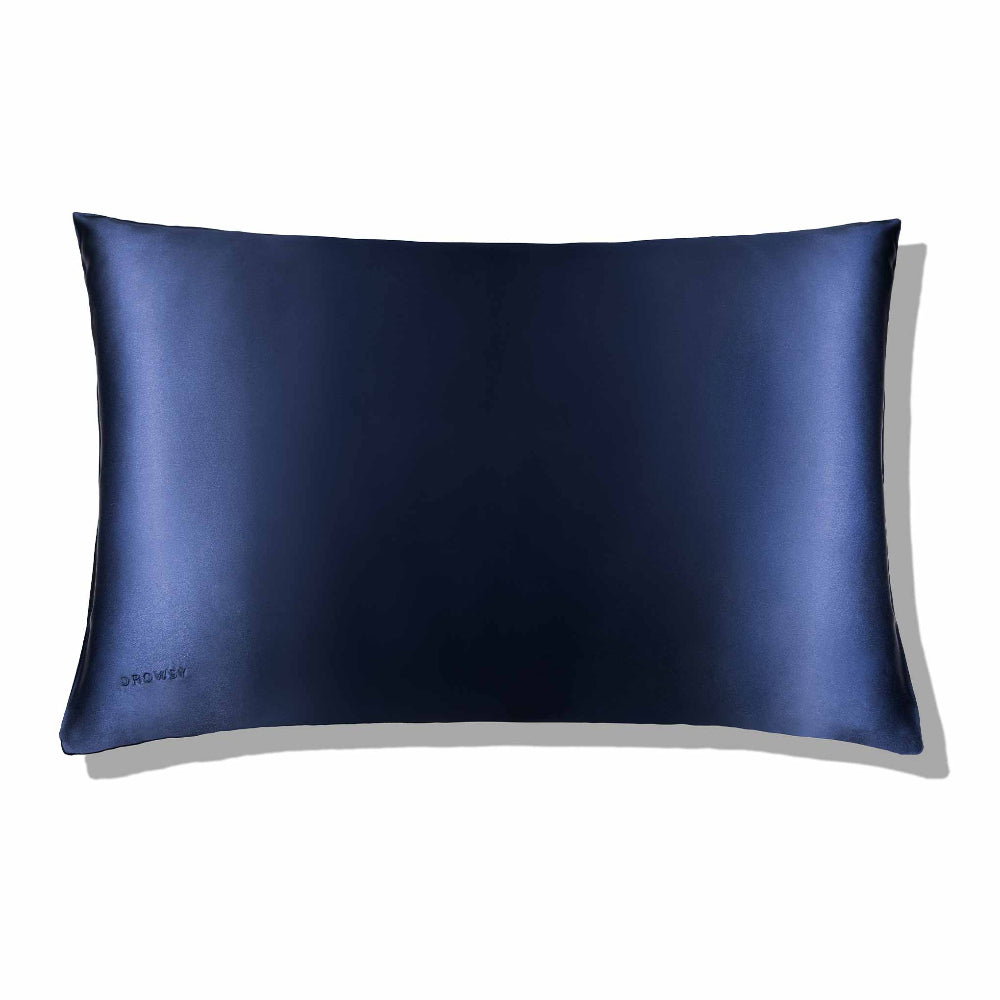 A midnight blue silk pillowcase with a smooth texture, displayed against a neutral background.