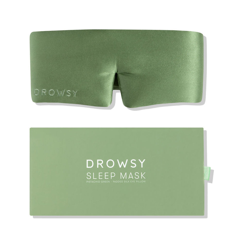 Green sleep mask with packaging on a white background