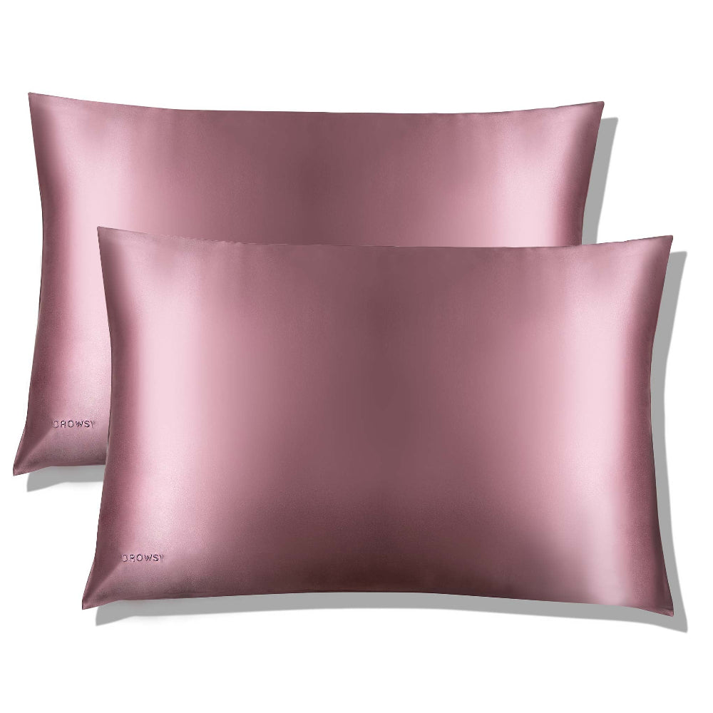 Two drowsy pink silk pillowcases with a luxurious sheen on a white background