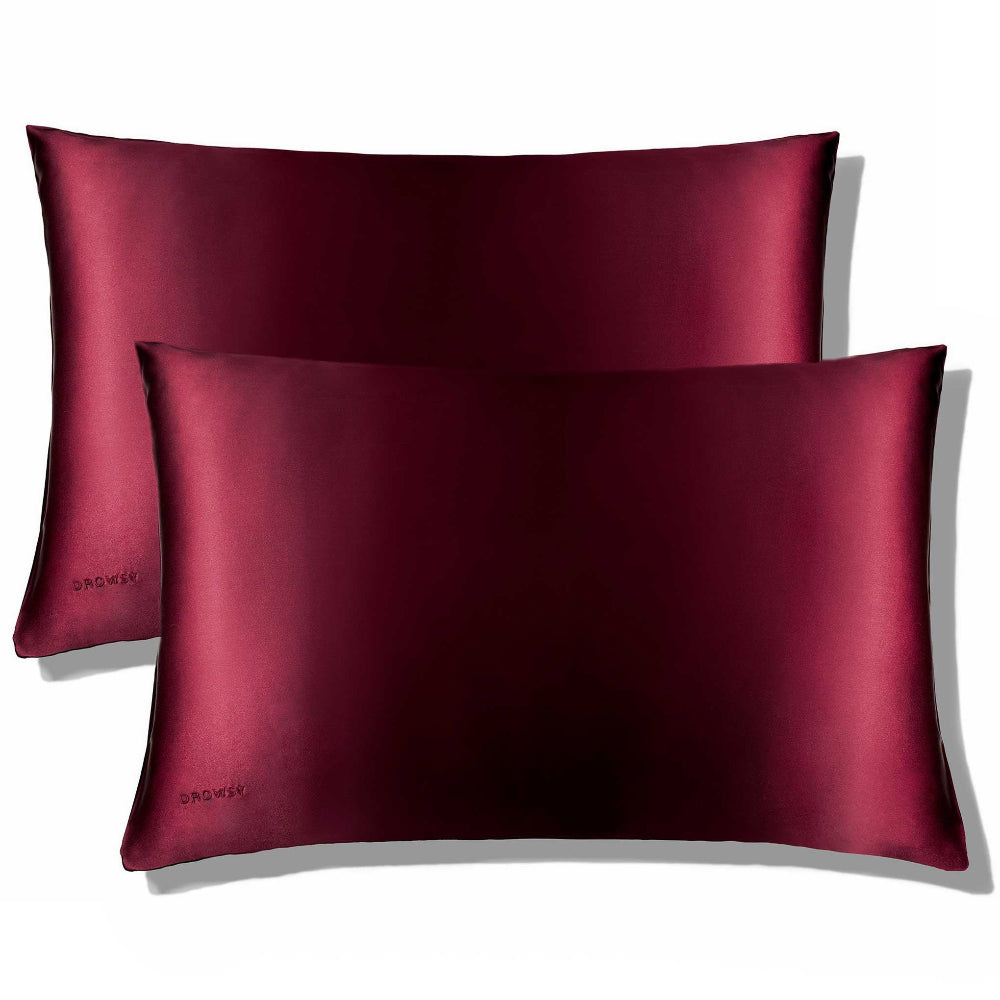 Two Drowsy La Vie En Rouge pillowcase with a luxurious sheen on a white background.
