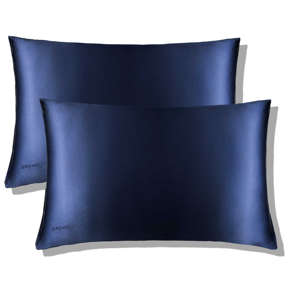 Two midnight blue silk pillowcases with a smooth texture, displayed against a neutral background.