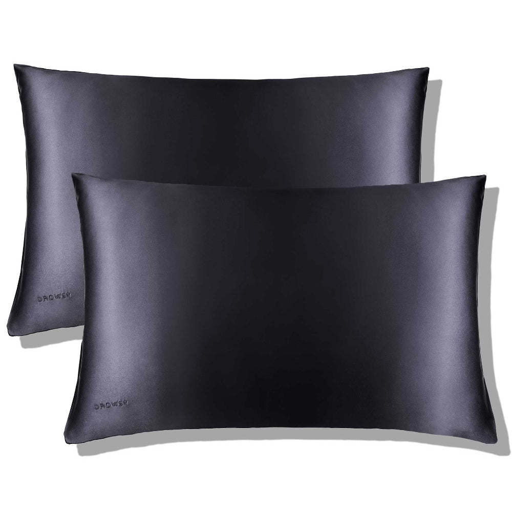 A closeup of two moonlight shadow pillowcases with a smooth texture, displayed against a neutral background.